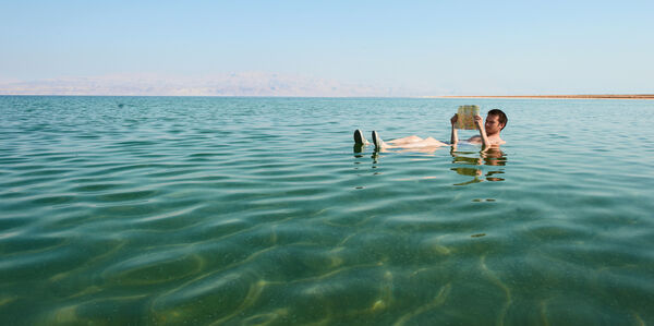 Shutterstock 93107599 Kaukasisk mann leser en bok flytende i vannet i Dødehavet i Israel