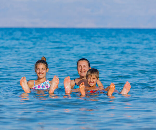 Family floating in Dead sea